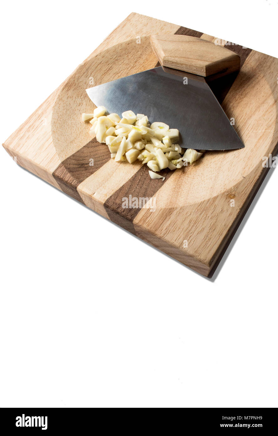 Alaskin Ulu with minced garlic off set to the top of photo. Stock Photo