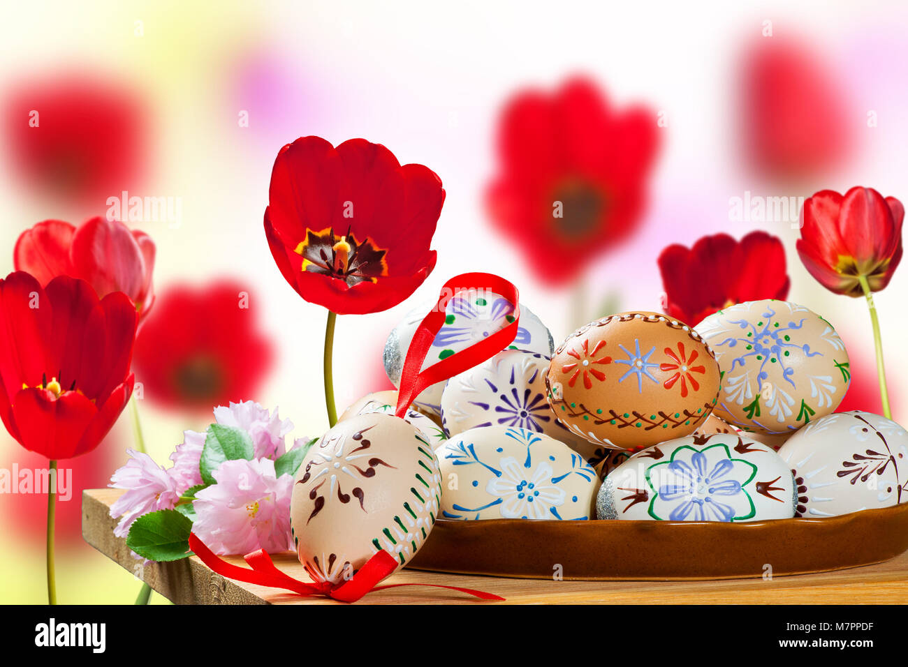 Painted Easter Eggs with Red Tulips in the Flower Bed Stock Photo - Alamy