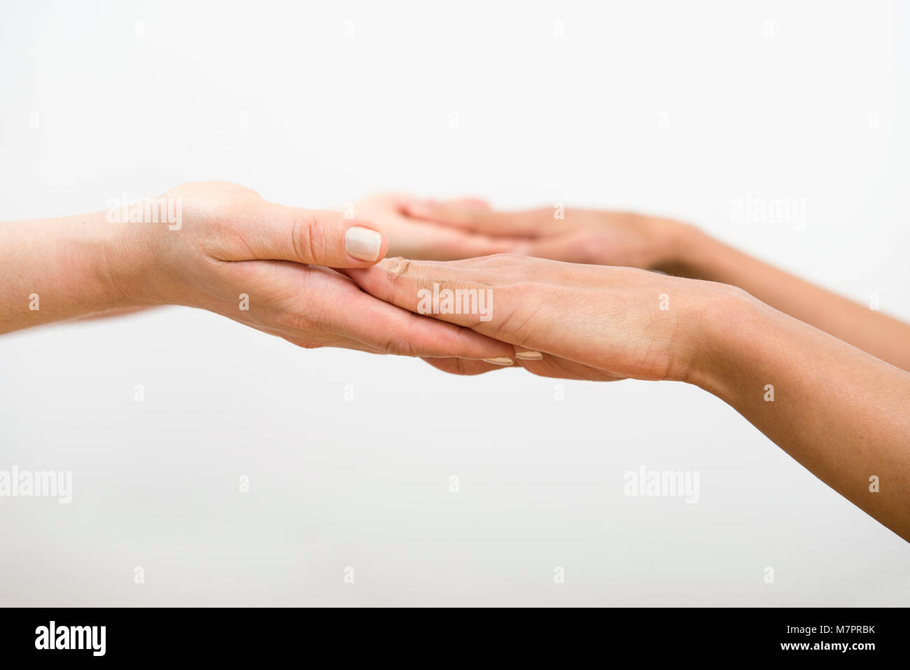 A close up of hands helping each other. In this case specifically for pilates. Stock Photo