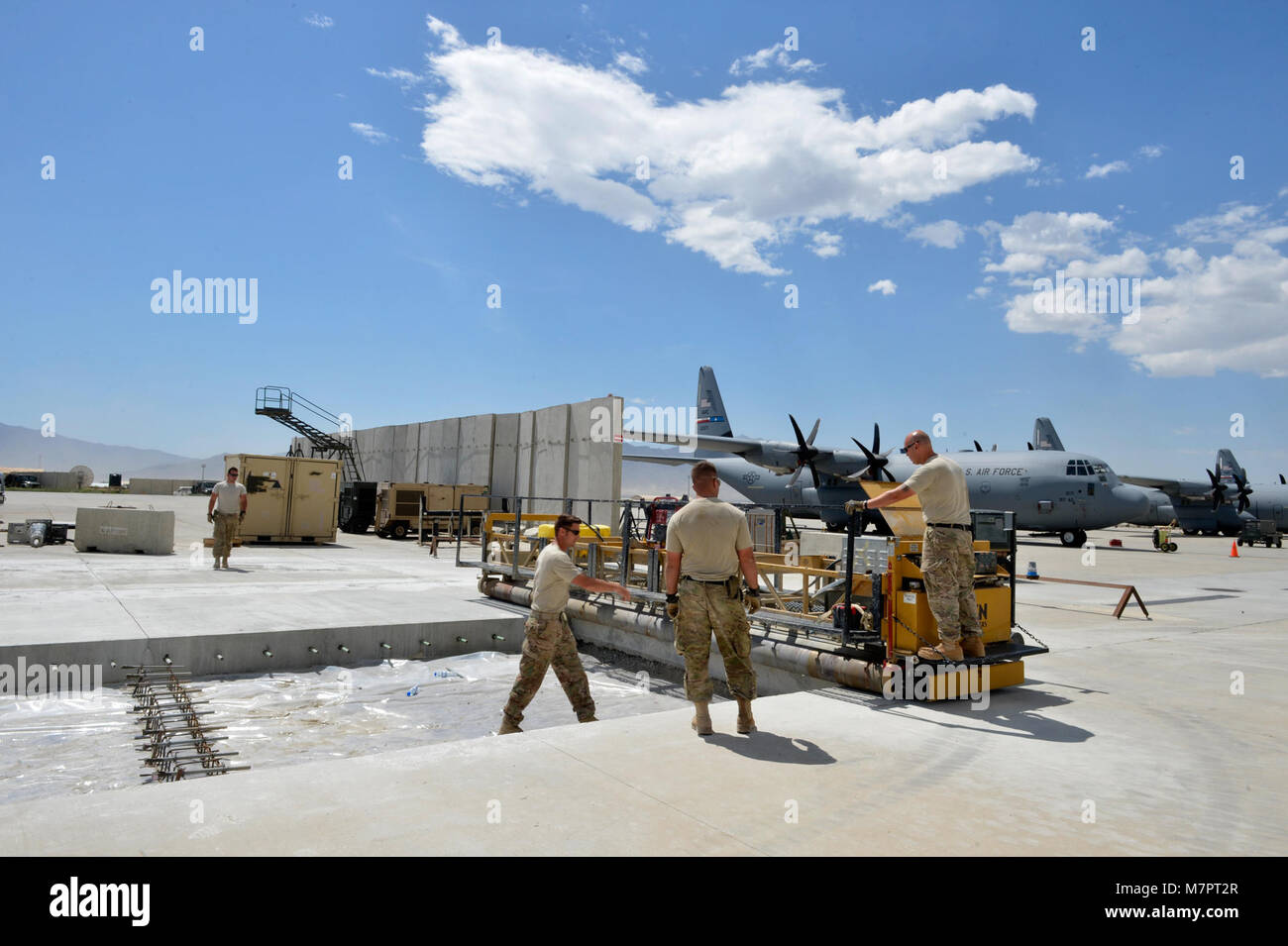 U.S. Air Force Airmen with the 455th Expeditionary Civil Engineer Squadron prepare to pour concrete on the flightline at Bagram Airfield, Afghanistan May 22, 2014. The 455 ECES ensures operability of the airfield by providing airfield maintenance, construction and operation for the senior airfield authority mission. (U.S. Air Force photo by Staff Sgt. Evelyn Chavez/Released) 455th Air Expeditionary Wing Bagram Airfield, Afghanistan Stock Photo
