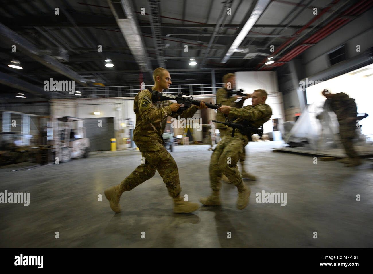 (From left) U.S. Air Force Airman 1st Class Jon Peterson, 455th Expeditionary Aerial Port Squadron aerial porter, and Senior Airman Cameron Corricelli, 455 EAPS aerial porter, participate in Check Six program instruction at Bagram Airfield, Afghanistan Oct. 21, 2014.  The program is designed to increase military members’ awareness and practice muscle memory that will become critical in the event of an attack or violent occurrence.  Peterson is deployed from Travis Air Force Base, Calif. and a native of Fairbanks, Alaska. Corricelli is deployed from Charleston Air Force Base, South Carolina and Stock Photo