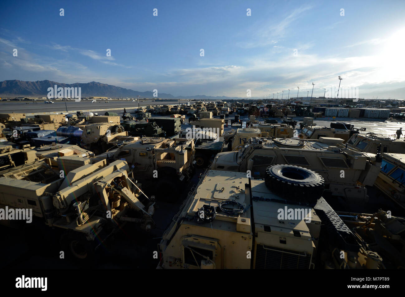 Military vehicles are lined up in the Expeditionary Aerial Port Squadron loading yard at Bagram Airfield, Afghanistan Oct. 23, 2014.  The 455 EAPS coordinates all equipment, personnel and life-saving supply movement that come into Afghanistan via the airfield.  They are the busiest aerial port squadron in the Department of Defense.  (U.S. Air Force photo by Staff Sgt. Evelyn Chavez/Released) 455th Air Expeditionary Wing Bagram Airfield, Afghanistan Stock Photo