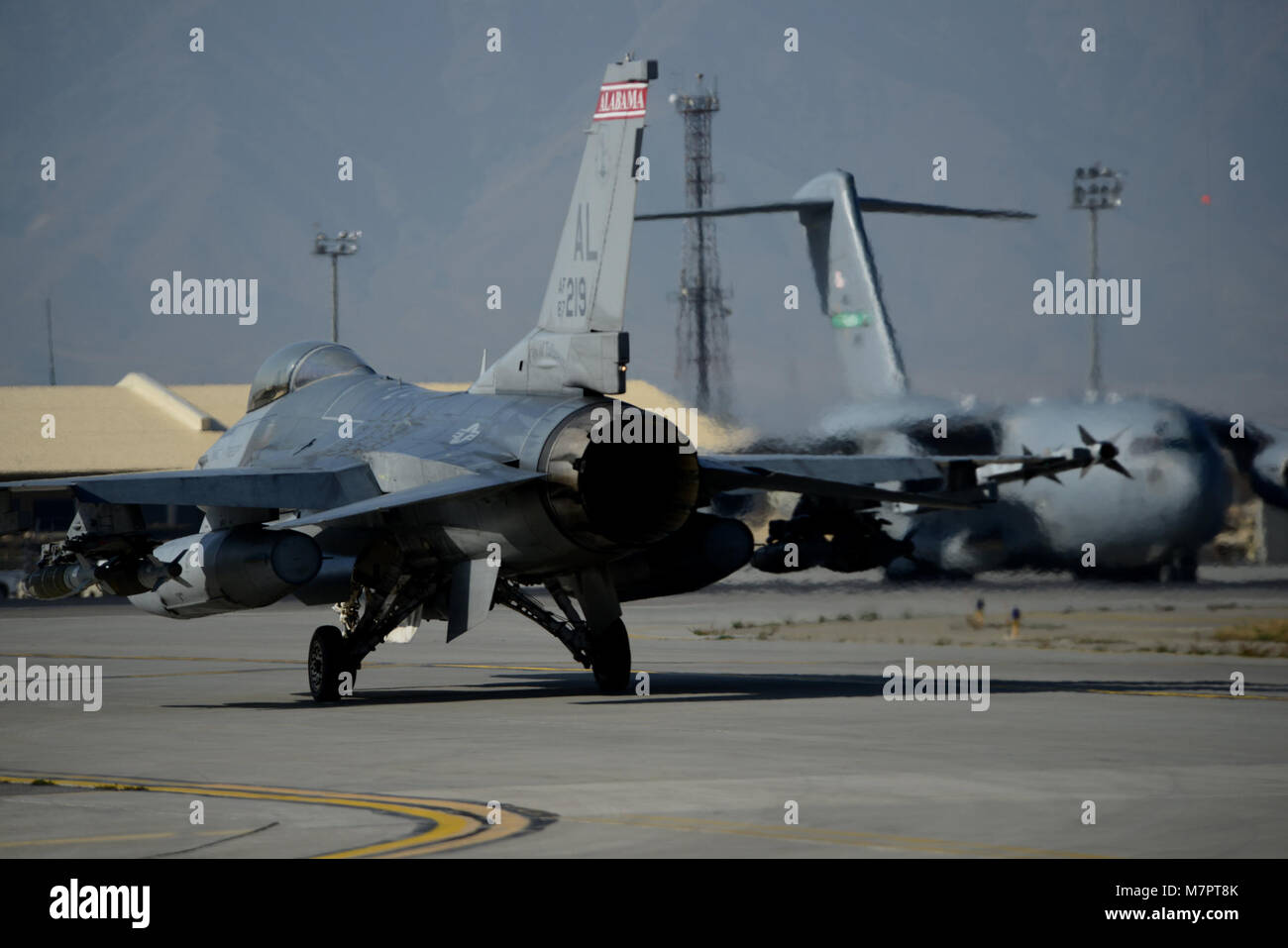A U.S. Air Force F-16C Fighting Falcon prepares for take off at Bagram Airfield, Afghanistan Oct. 24, 2014.  Deployed service members help operate 46 different types of aircraft in-and-out of the buisiest single runway airfield in the Department of Defense. (U.S. Air Force photo by Staff Sgt. Evelyn Chavez/Released) 455th Air Expeditionary Wing Bagram Airfield, Afghanistan Stock Photo