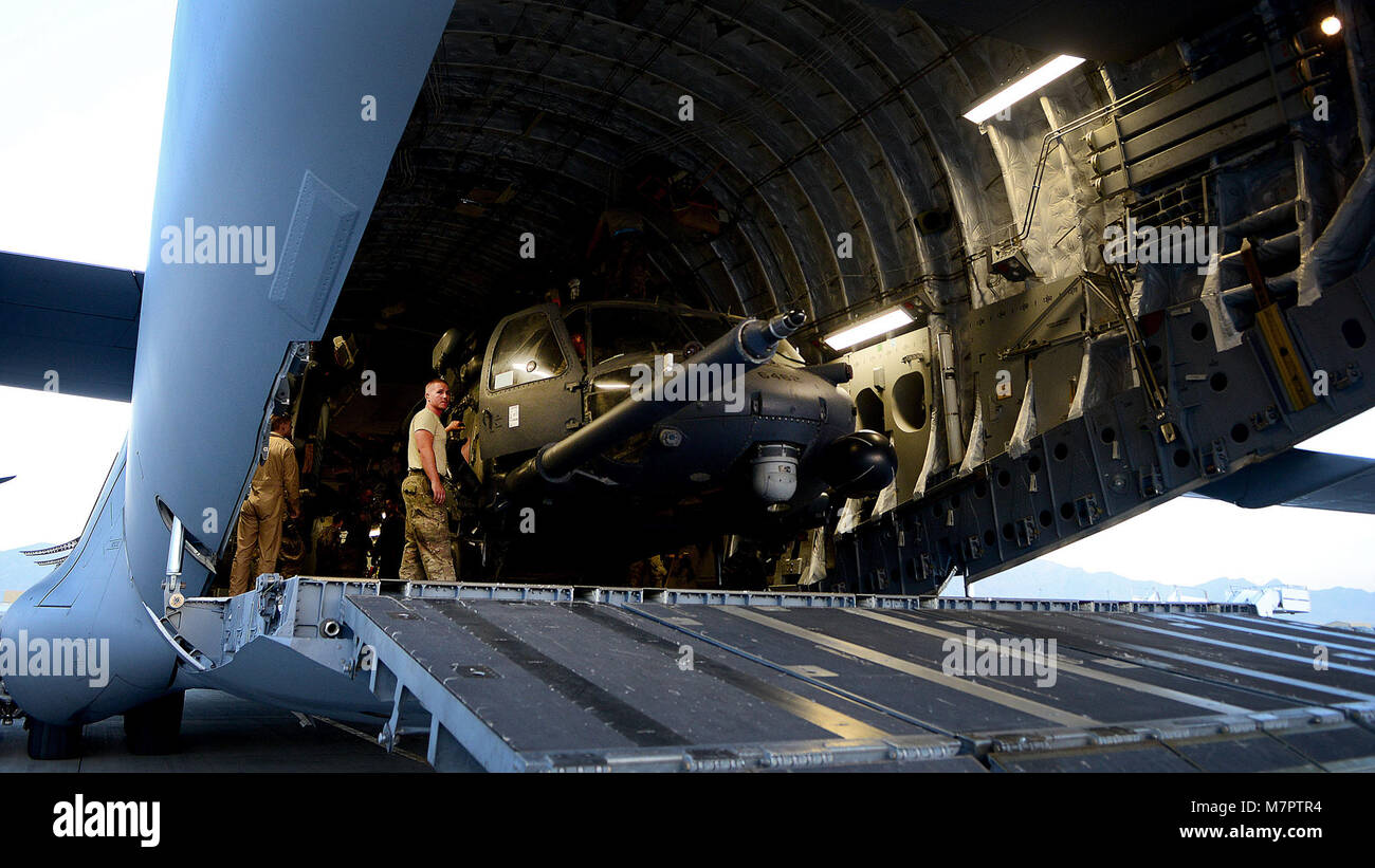 A U.S. Air Force Airman from the 455th Expeditionary Aircraft Maintenance Squadron, secures an HH-60G Pave Hawk helicopter inside a C-17 Globemaster aircraft at Bagram Airfield, Afghanistan June 9, 2014. The unit is preparing their helicopters for redeployment to their home base, Moody Air Force Base, Georgia. Maintainers here work a non-stop alert schedule and are ready to respond 24 hours a day, seven days a week. (U.S. Air Force photo by Staff Sgt. Evelyn Chavez/Released) 455th Air Expeditionary Wing Bagram Airfield, Afghanistan Stock Photo