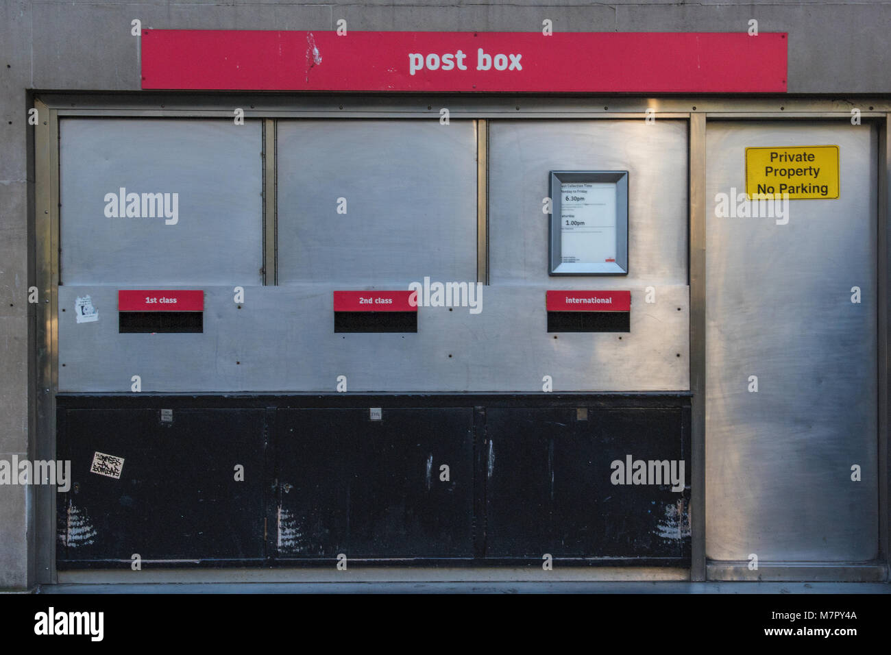 a dated or vintage 1970's style post office posting or collection box in central london
