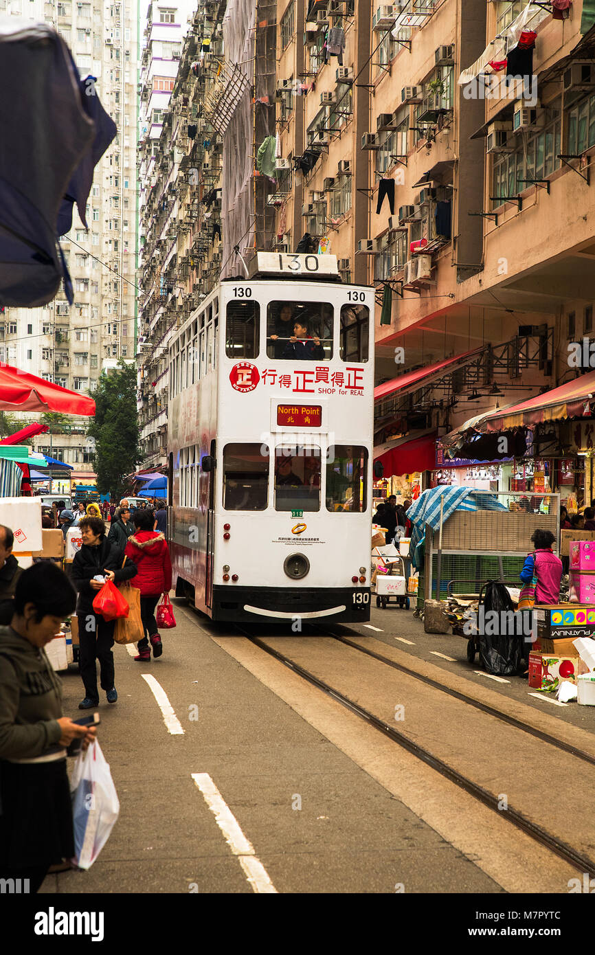 Tram at narrow market street North Point, Hong Kong Stock Photo