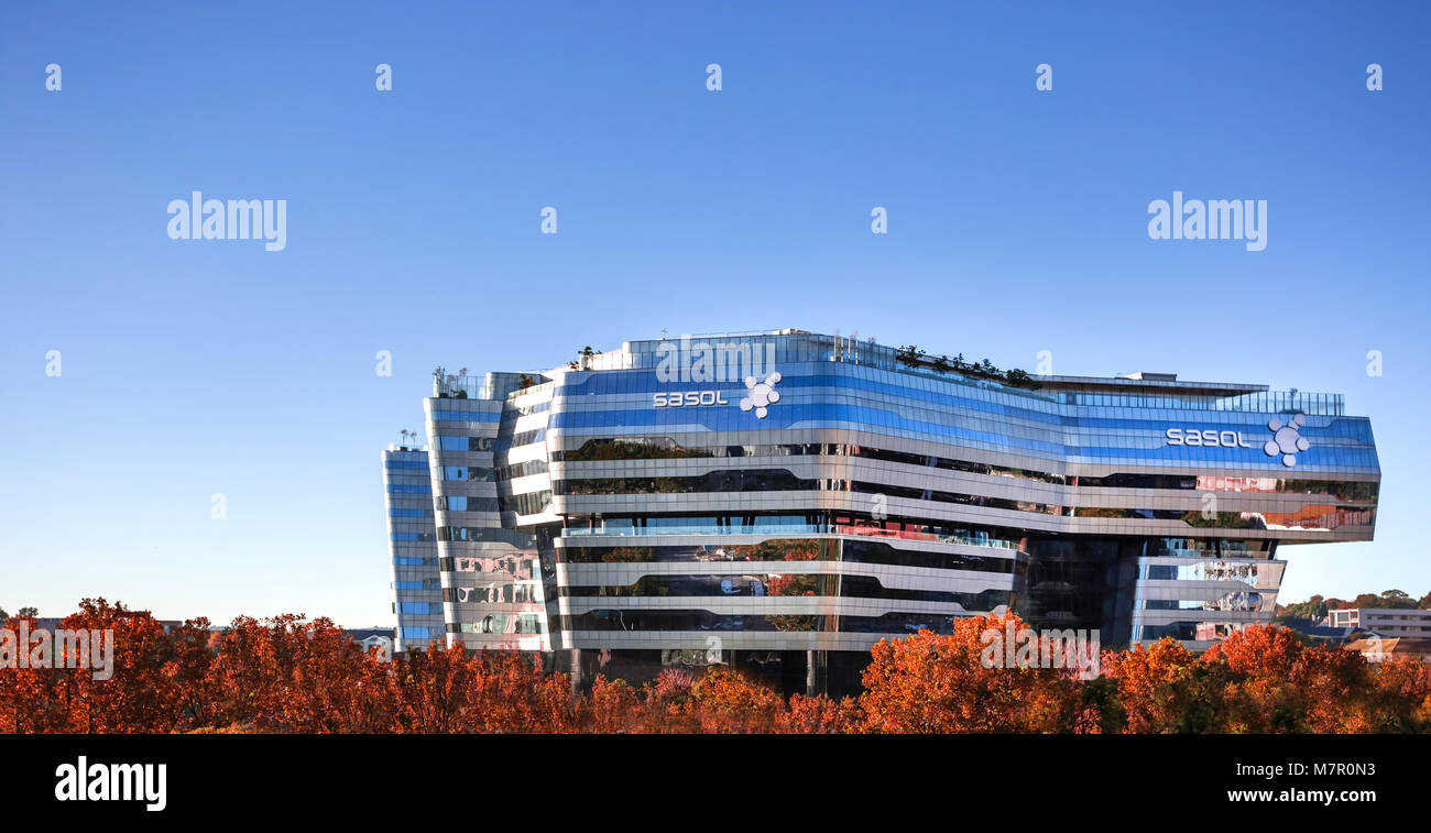 Johannesburg, South Africa - March 8, 2018: Modern glass building with trees in foreground. Stock Photo