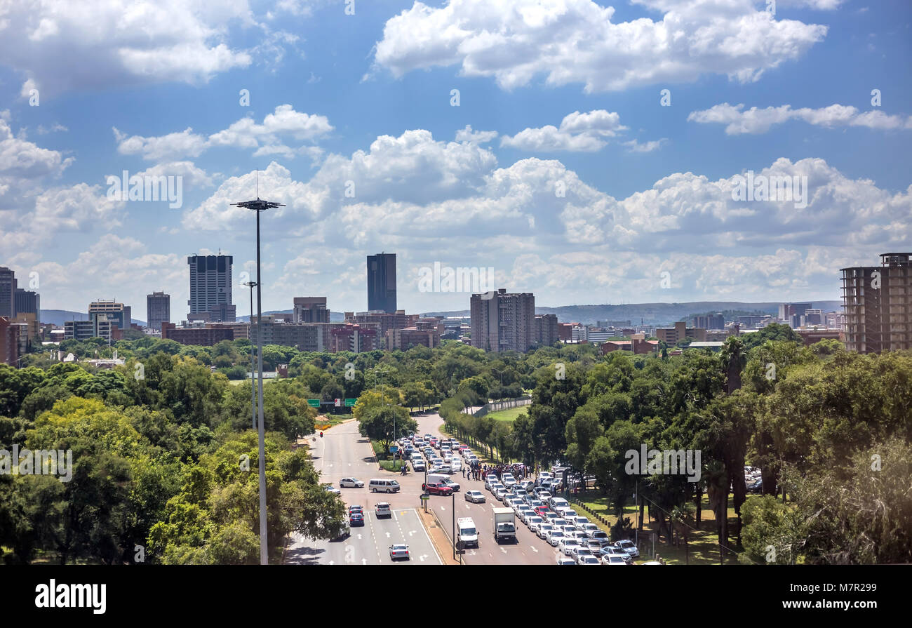 Pretoria, South Africa - March 8, 2018: Road leading to city with trees in foreground. Stock Photo