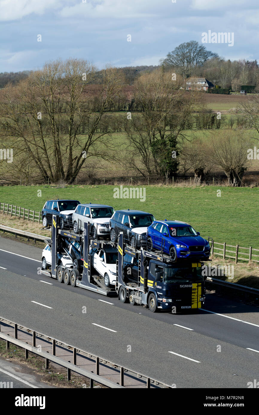 New Jaguar and Land Rover cars on a transporter on the M40 motorway, Warwickshire, UK Stock Photo