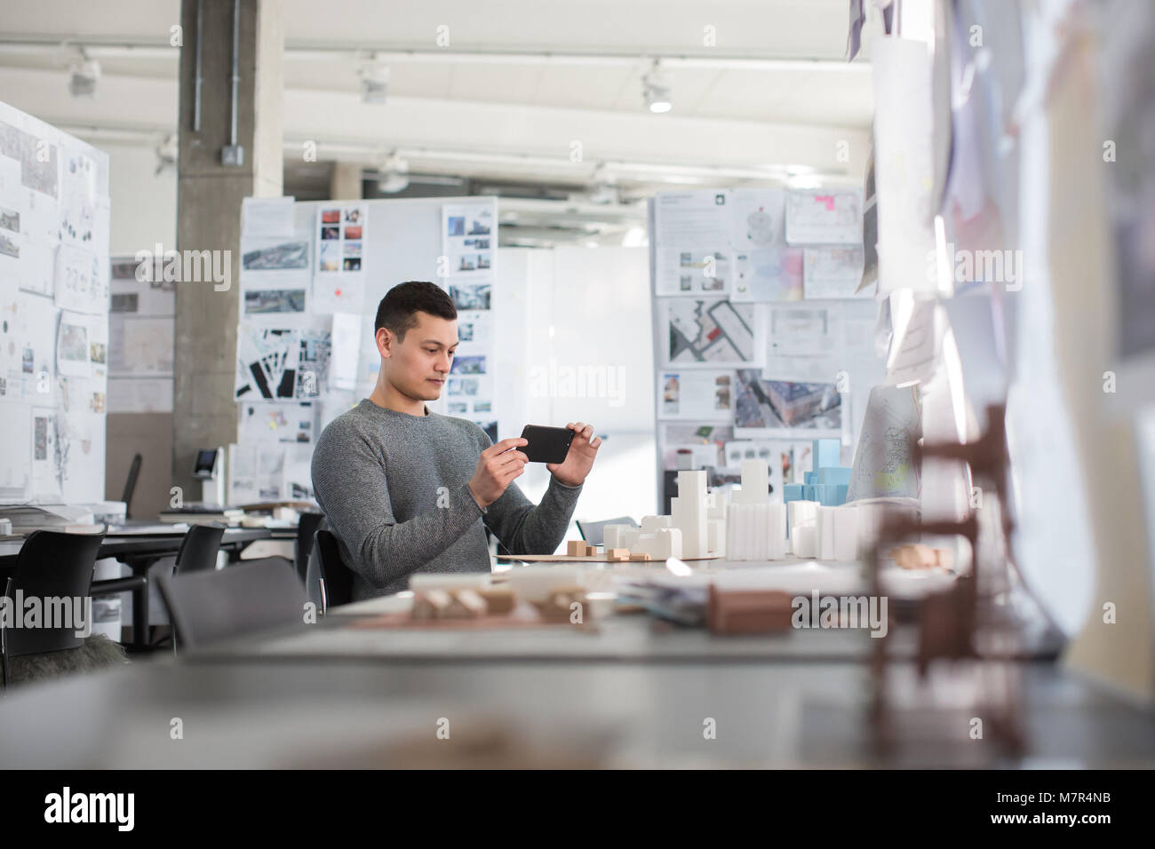 Architect taking photo of model in studio Stock Photo