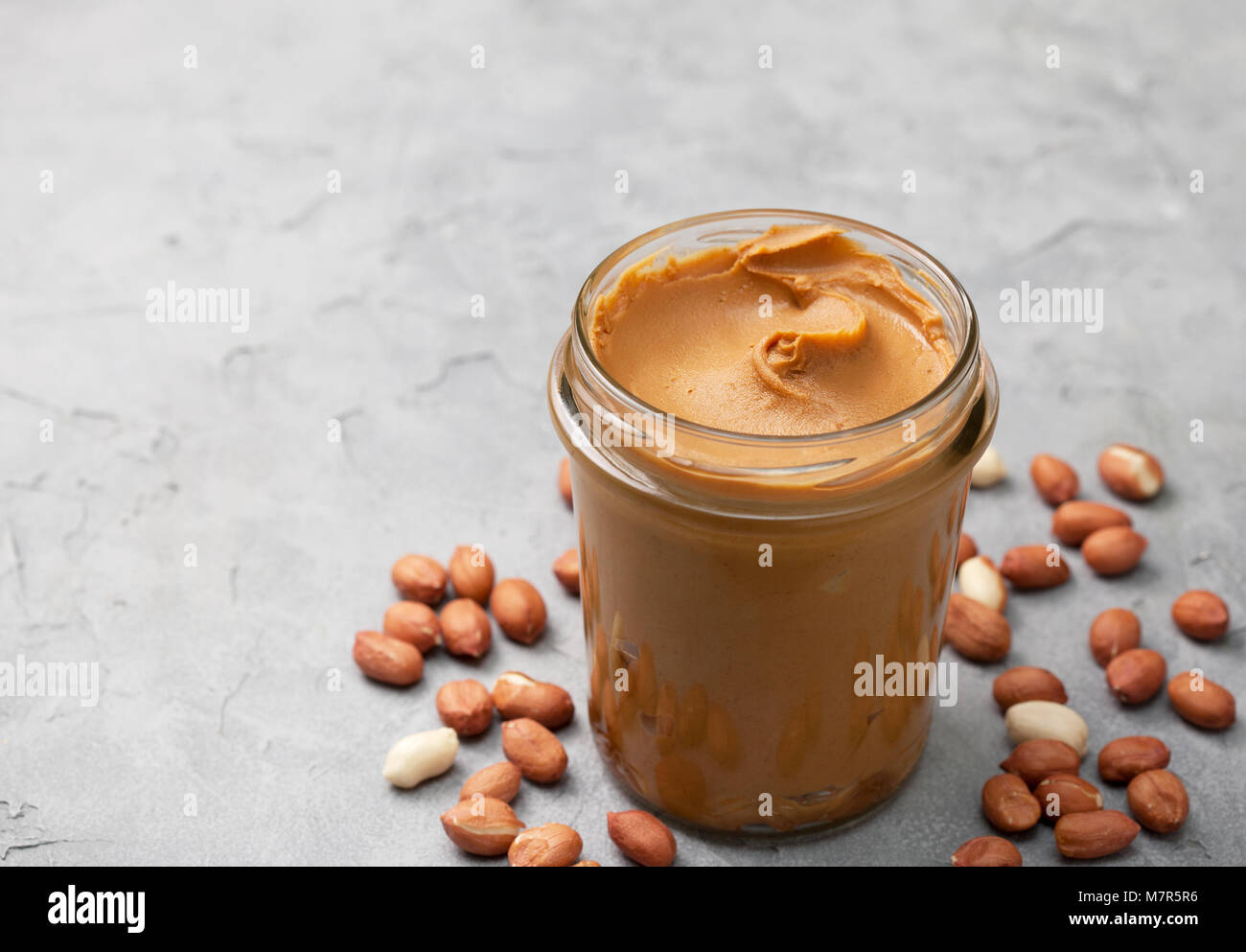 Jar with peanut butter and knife butter smear isolated on white background.  Ameriacan dessert concept Stock Photo - Alamy