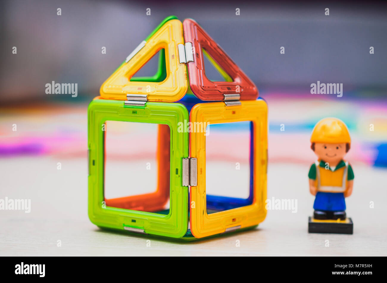 Construction worker and building industry concept. Toy house miniature