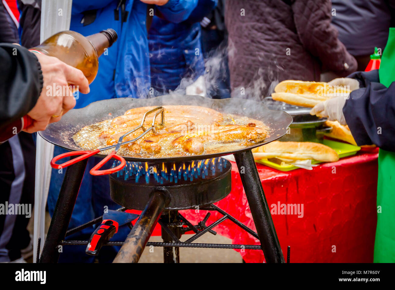 Traditional homemade pork sausages are simmering on barbecue grill