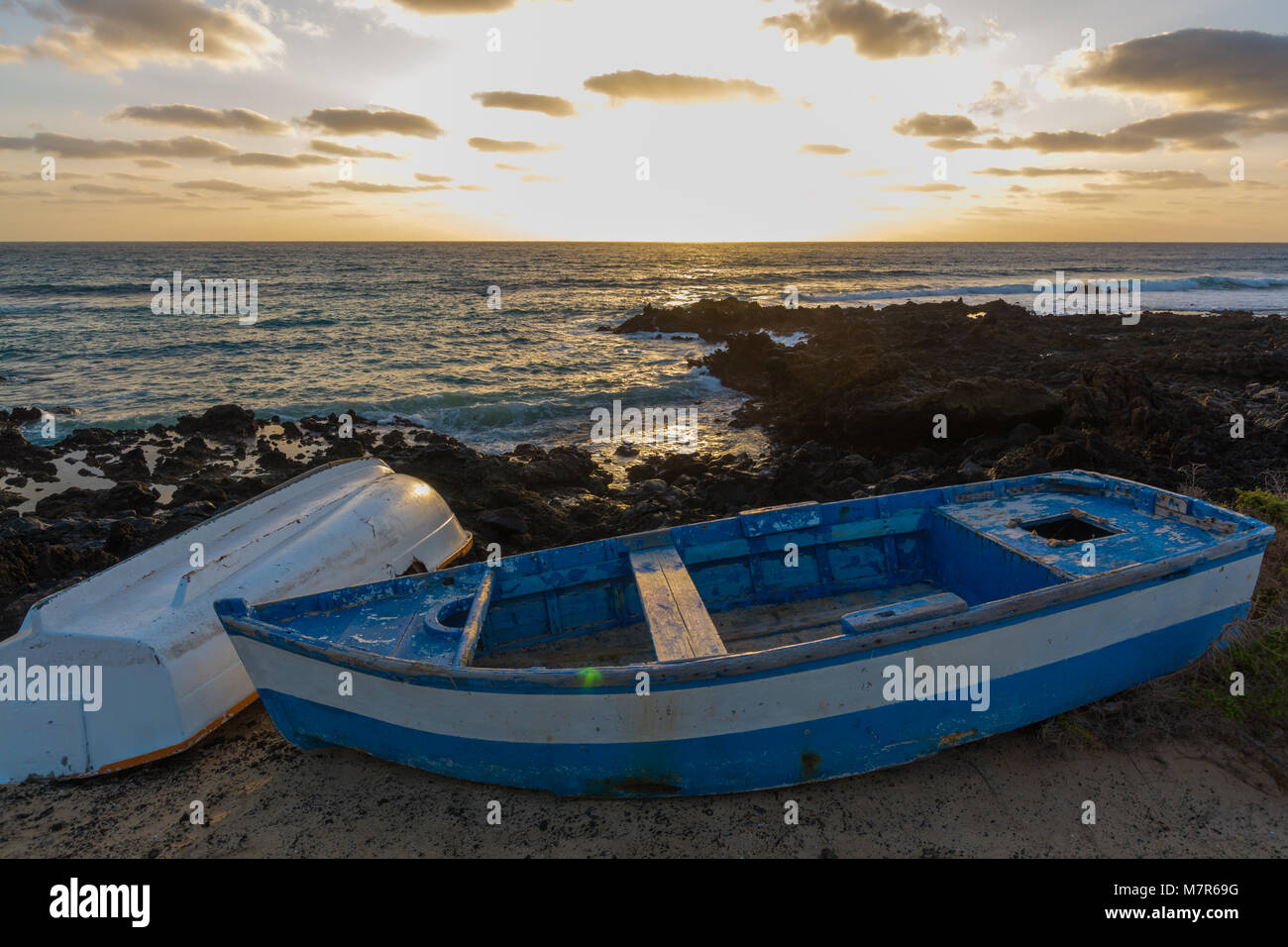 Sunset over the sea landscape with old blue wooden fishing boat Stock ...