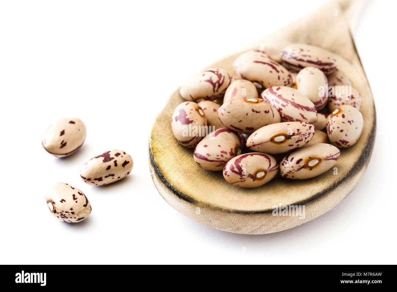 Raw pinto beans on wooden spoon isolated on white background Stock Photo