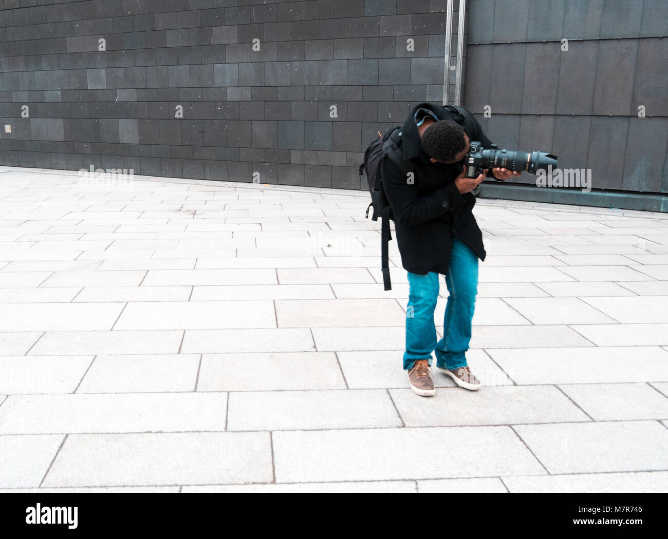 Ambitious photographer with big dslr camera, Köln, Domplatte Stock Photo