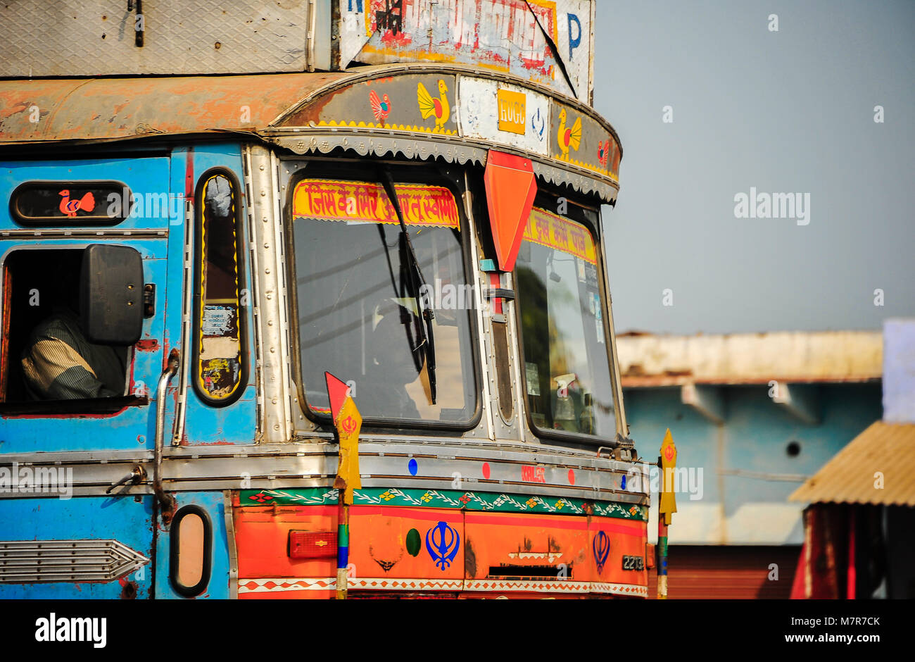 Agra-Jaipur Route NH21: Brightly painted cab of a truck which is a travelling home to it's driver,  Elaborately decorated for luck and safe travels Stock Photo