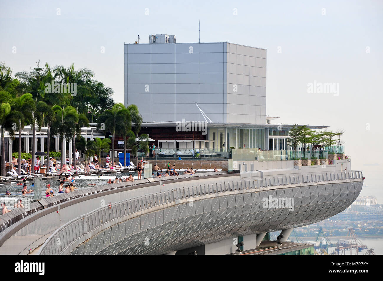 Rooftop infinity pool at the Marina Bay Sands Skypark, in Singapore showing people relaxing to