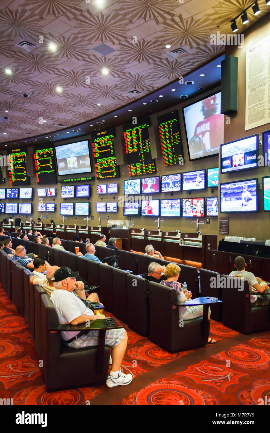 Las Vegas, USA - May 16, 2012. Tourists watch sports on TV screens in a casino in MGM Grand Hotel. Stock Photo