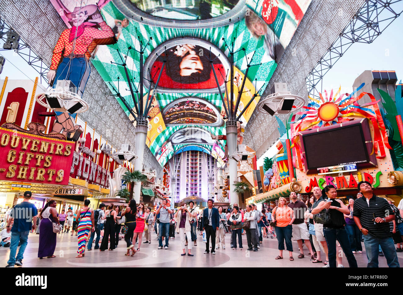 Las Vegas, USA - May 19, 2012. Tourists outside the Pioneer Cowboy Vegas Vic neon sign watch the Fremont Street Experience light show, Fremont Street Stock Photo