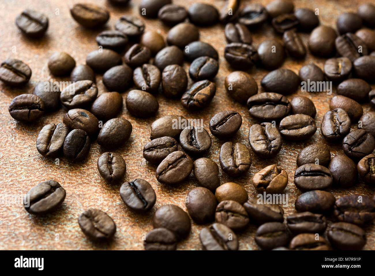 Roasted coffee beans on brown rustic background Stock Photo - Alamy
