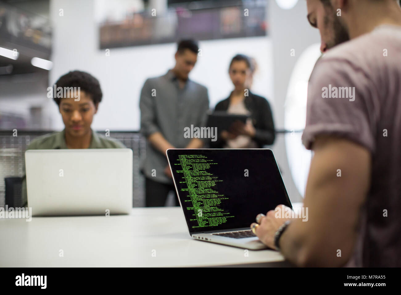 Coders working in an office Stock Photo