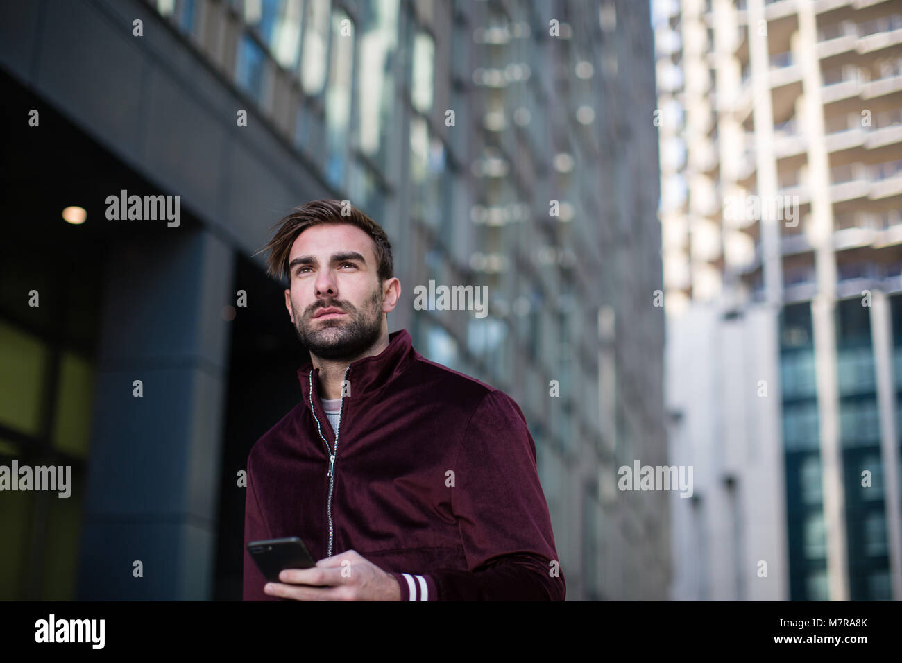 Young adult male walking in city Stock Photo