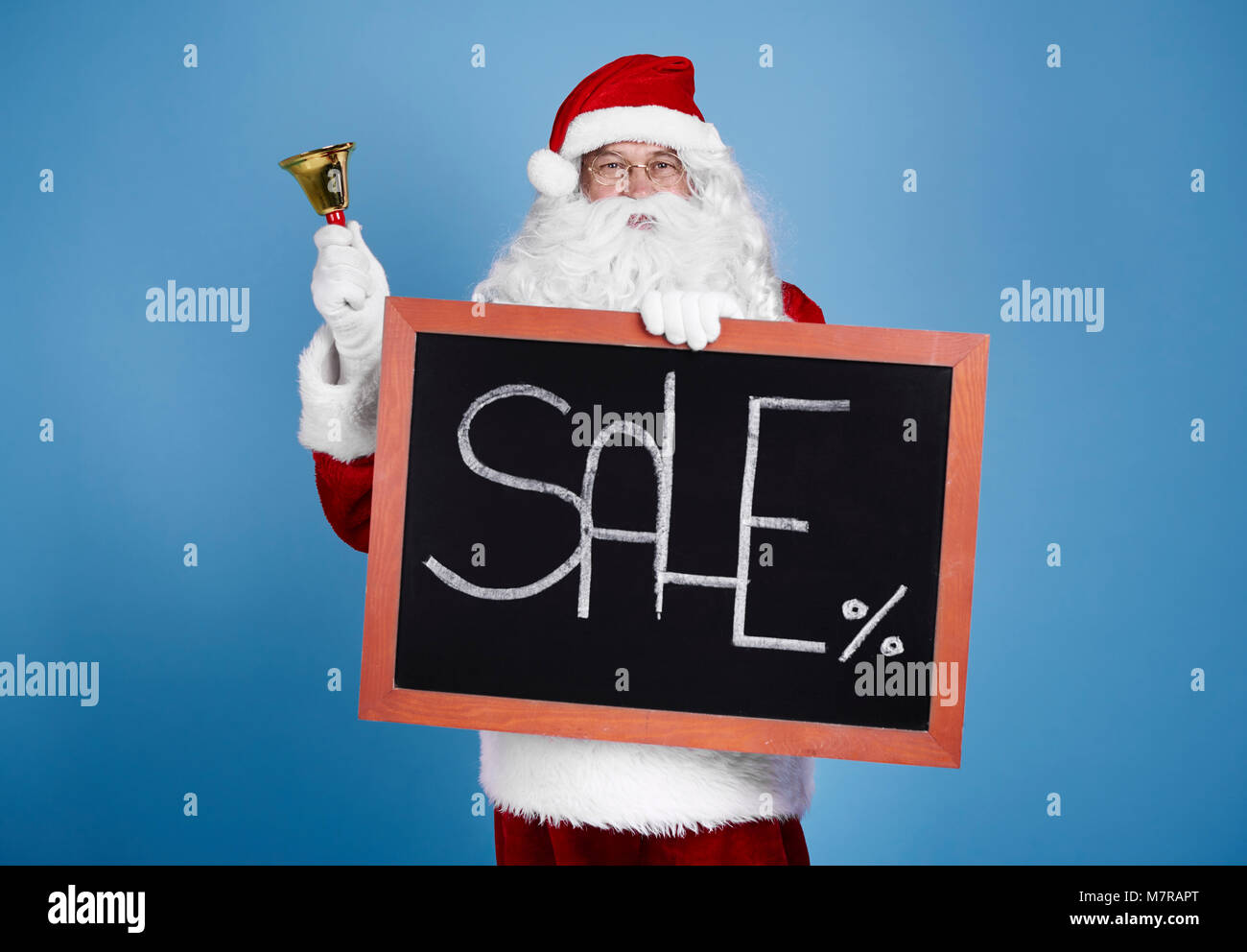 Portrait of santa claus holding blackboard and bell Stock Photo - Alamy