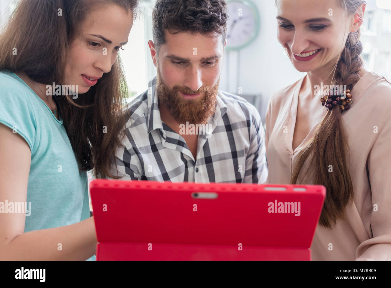 Reliable digital nomads helping their co-worker during remote work Stock Photo