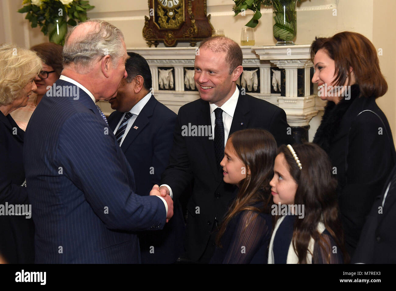 The Prince of Wales (left) meets meets the Prime Minister of Malta Joseph Muscat (centre), his wife Michelle Muscat (right) and their daughters at a reception held by the Commonwealth Secretary-General, Rt Hon Patricia Scotland QC, at Marlborough House, the home of the Commonwealth Secretariat in London. Stock Photo