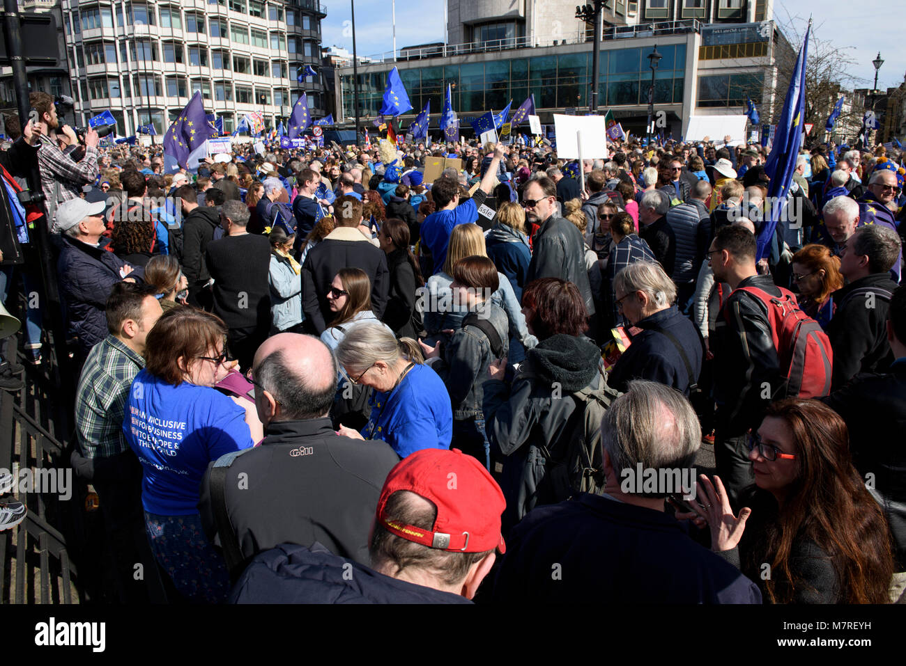 A crowd of EU supporters holding anti-Brexit placards and waving EU flags during the Unite for Europe march - anti-Brexit protest in London, UK. Stock Photo