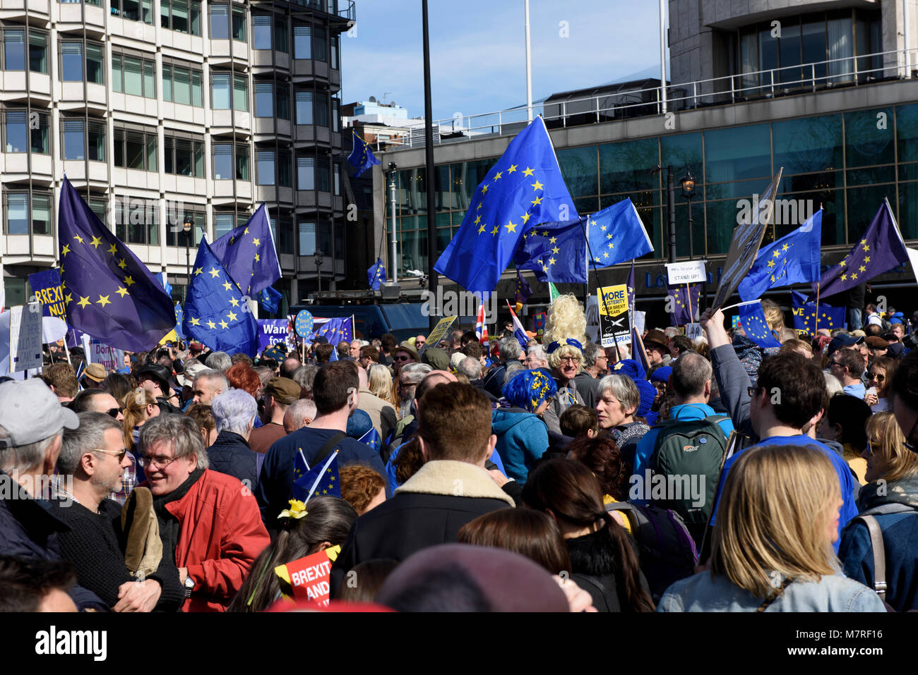 A crowd of EU supporters holding anti-Brexit placards and waving EU flags during the Unite for Europe march - anti-Brexit protest in London, UK. Stock Photo