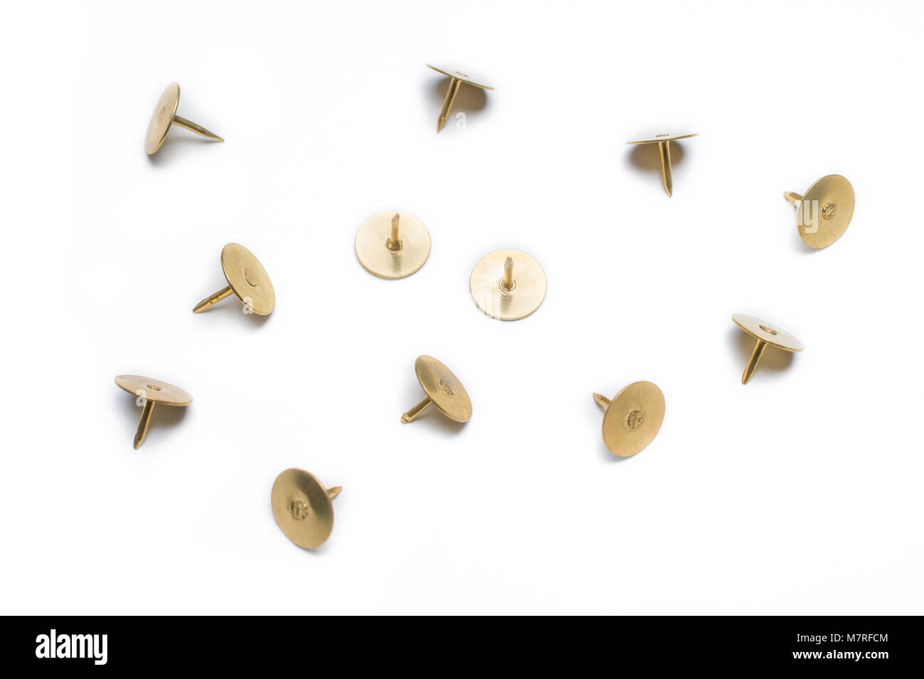 Medium Size Collection Of 4 Brass Thumbtacks On White Background Stock