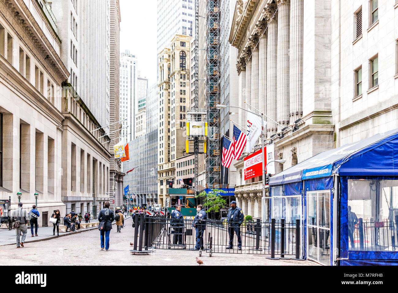 New York City, USA - October 30, 2017: Wall street, NYSE stock exchange building entrance, security, police guards, railing in NYC Manhattan lower fin Stock Photo