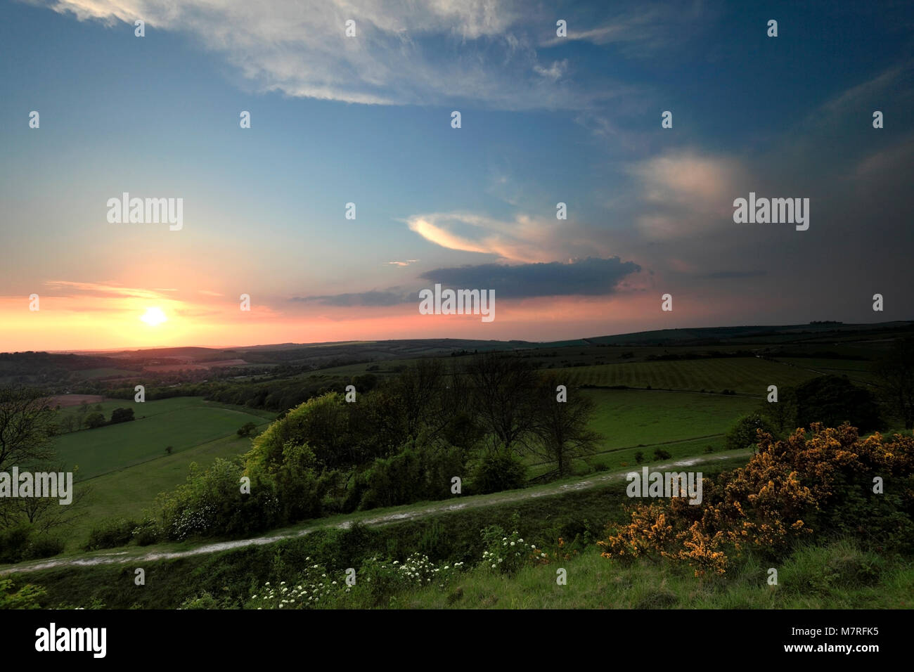 Sunset over the village of Findon from Cissbury Ring, South Downs ...