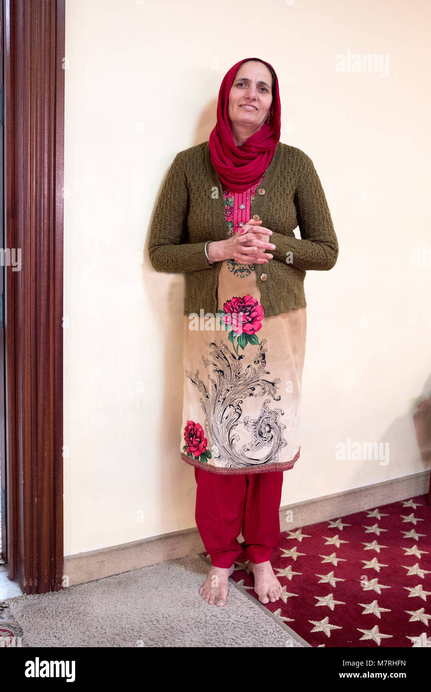 An attractive Sikh woman wearing a chuni head covering at the Gurdwara