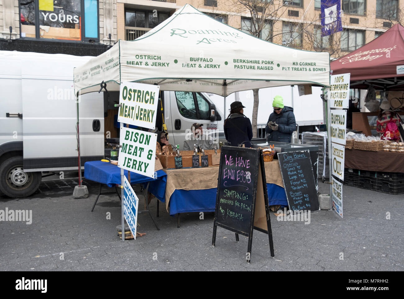 A butcher stand at the Union Square Green Market selling unusual meats including bison, ostrich and buffalo. In Manhattan, New York City. Stock Photo