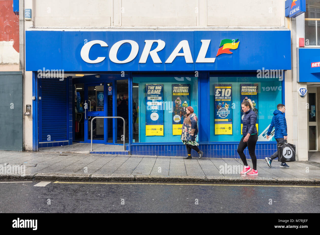 People walking past a coral bookmakers / betting shop facade on Southampton High Street, Southampton England, UK Stock Photo