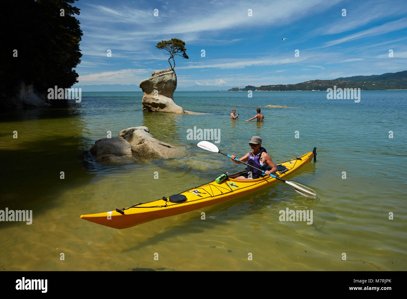 Kayaker and swimmers, Tinline Bay, Abel Tasman National Park, Nelson ...