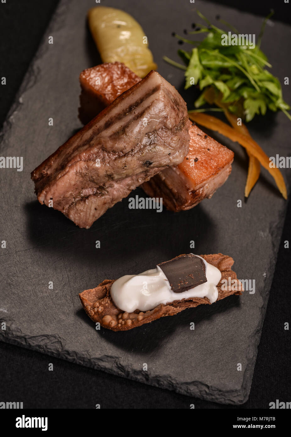 Black pig with candied orange and cannolo Stock Photo