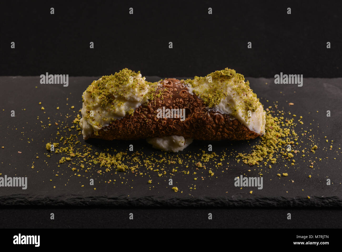 Cannolo with ricotta of sheep and pistachio of bronte Stock Photo