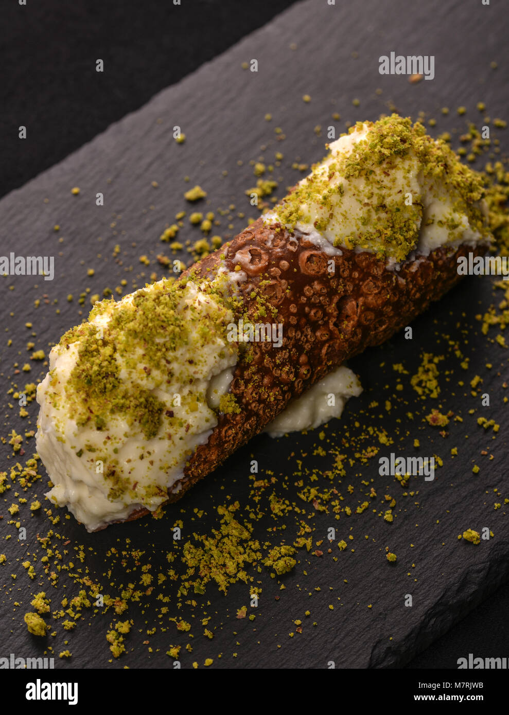 Cannolo with ricotta of sheep and pistachio of bronte Stock Photo