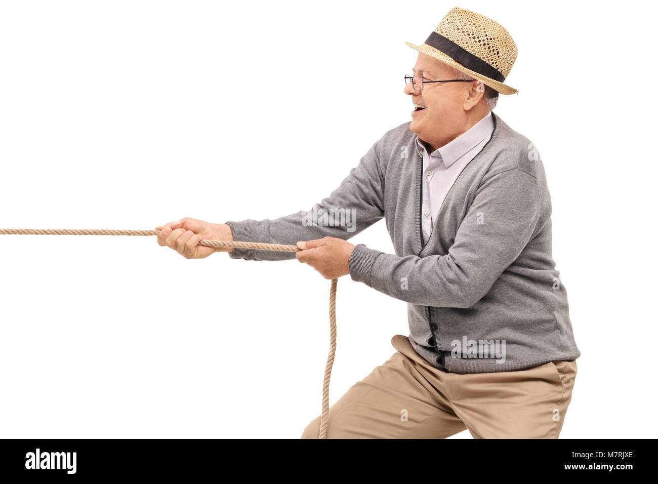 Senior pulling a rope isolated on white background Stock Photo