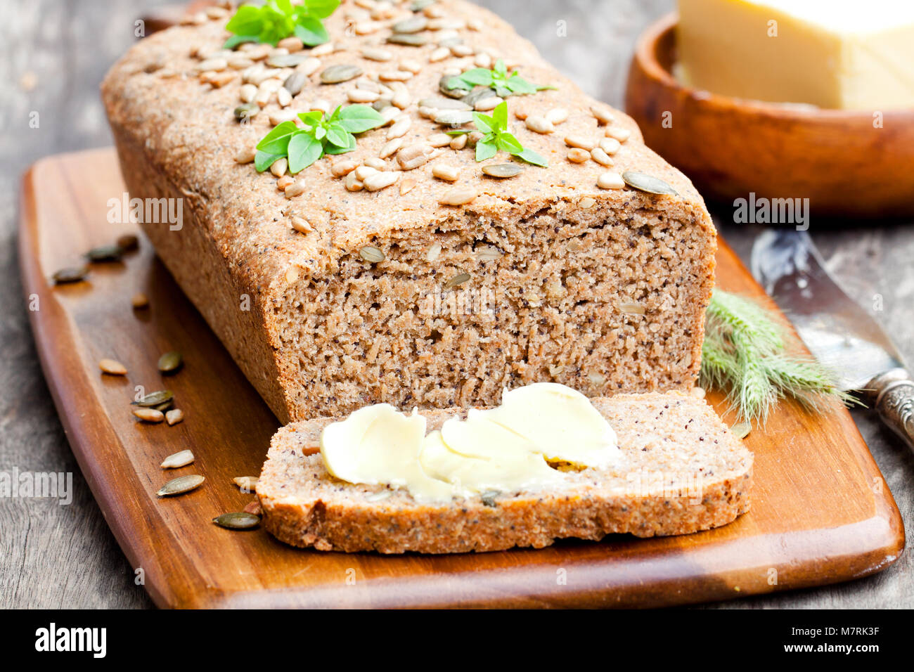 Homemade sliced rye bread with sunflower seeds and fresh butter Stock