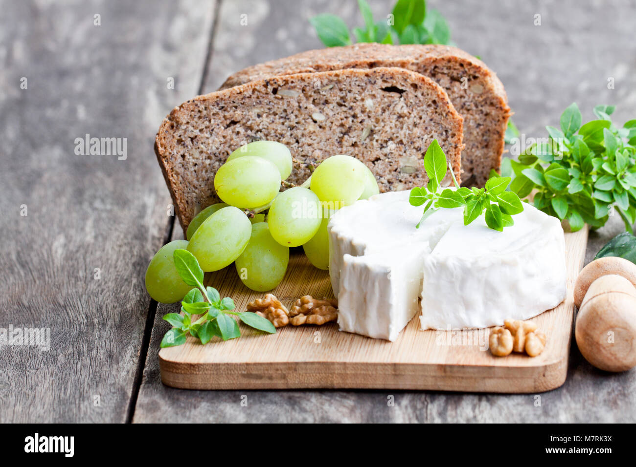 Goat cheese with fruits and whole grain bread Stock Photo Alamy