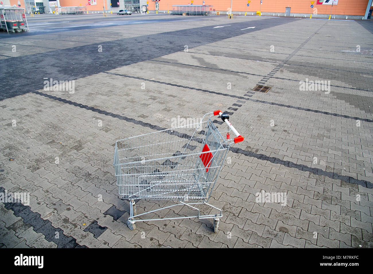 Parked shopping carts equipped with coinoperated locking mechanisms in