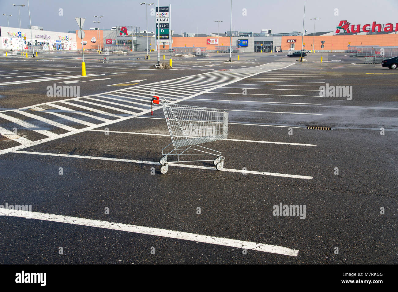 Parked shopping carts equipped with coinoperated locking mechanisms in