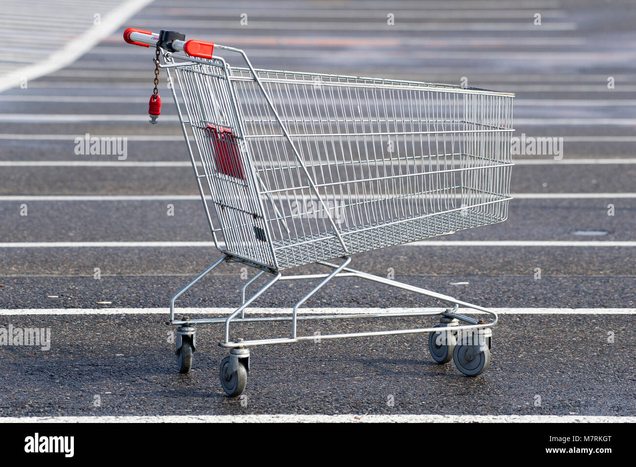 Parked shopping carts equipped with coinoperated locking mechanisms in