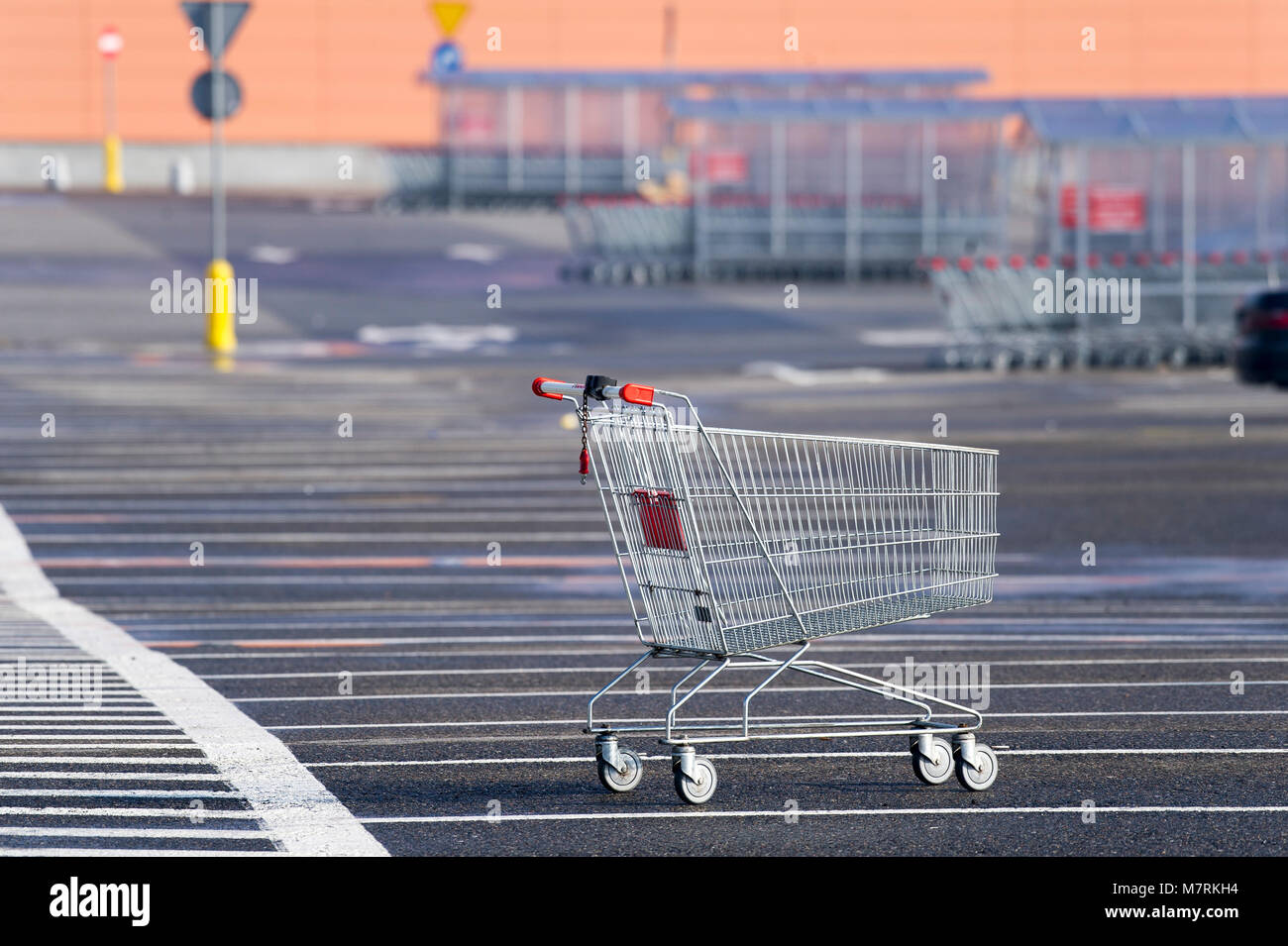 Parked shopping carts equipped with coinoperated locking mechanisms in