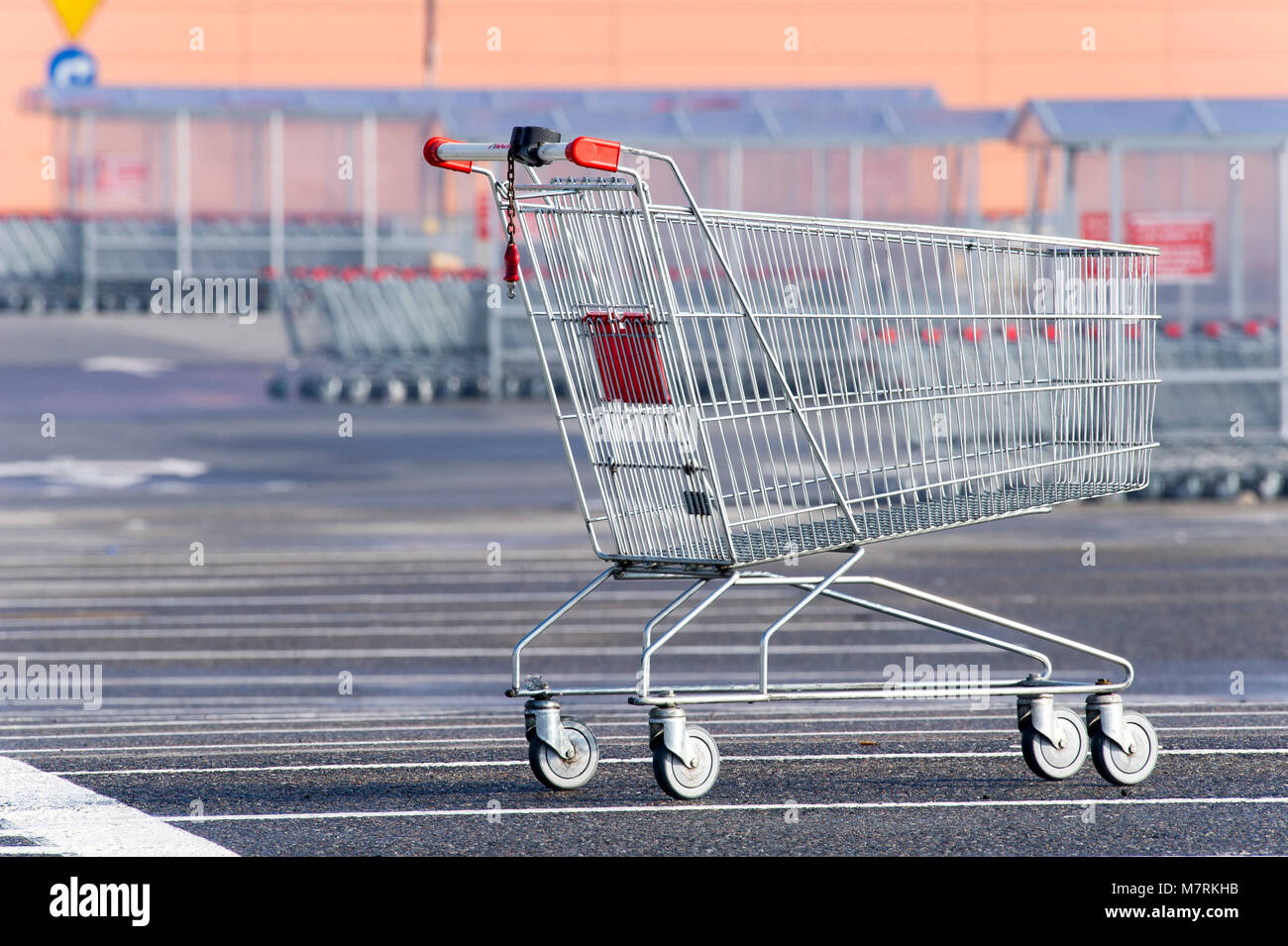 Parked shopping carts equipped with coinoperated locking mechanisms in